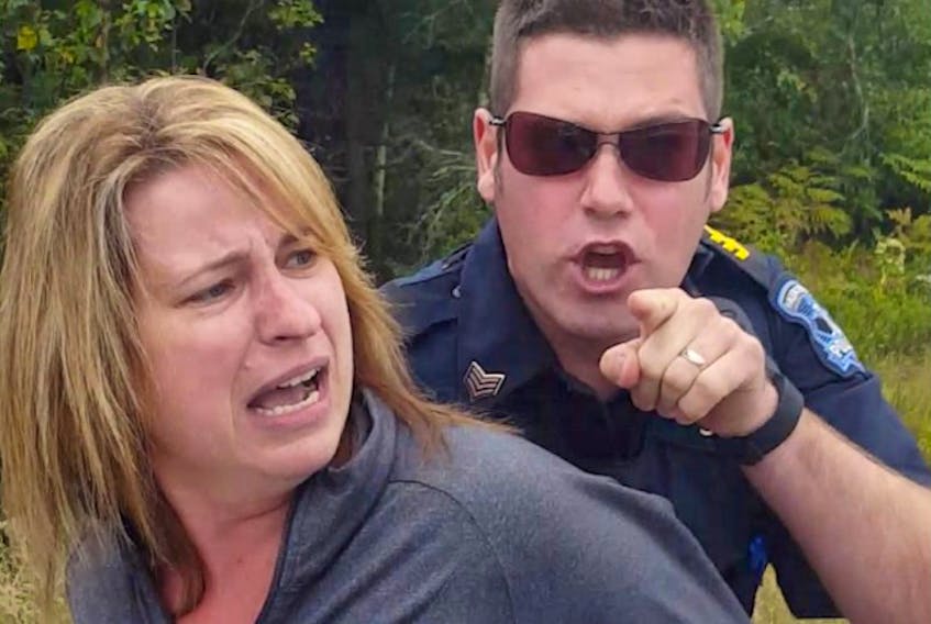 Halifax Regional Police Const. Matthew MacGillivray, right, points at Graham Labonte and says “You are both under arrest!” while restraining Angela Acorn during a traffic stop in September 2015. Labonte was recording the incident with a cellphone.