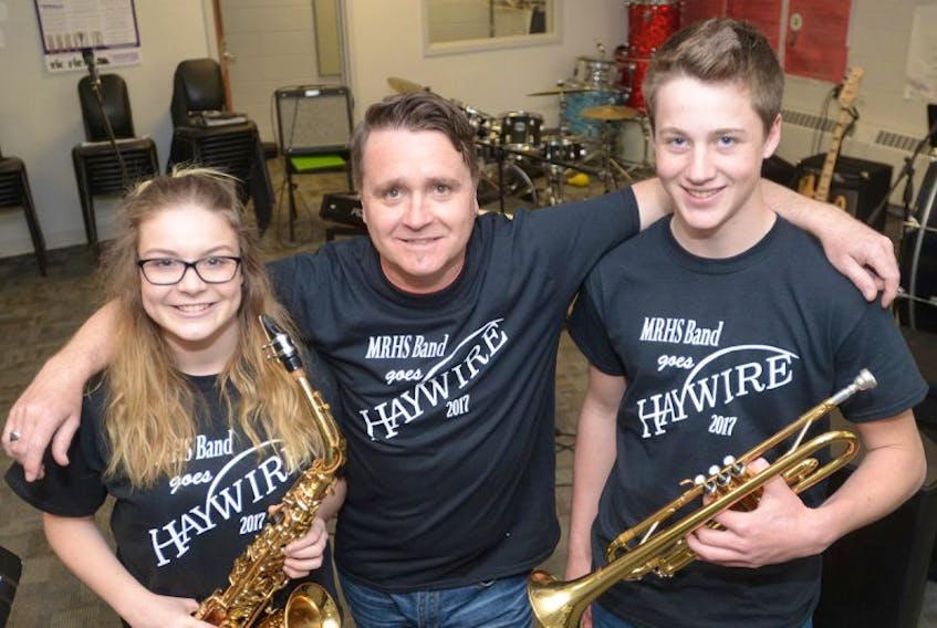 Montague Regional High School (MRHS) students Sam Martell, left, and Merlin M’Cloud, right, along with music teacher Kirk White get ready to rock at the MRHS Band Goes Haywire concert being held at the school next Tuesday. The concert will see the school’s current performing band collaborate with Haywire guitarist Marvin Birt for a version of the Charlottetown band’s 1987 hit Dance Desire.