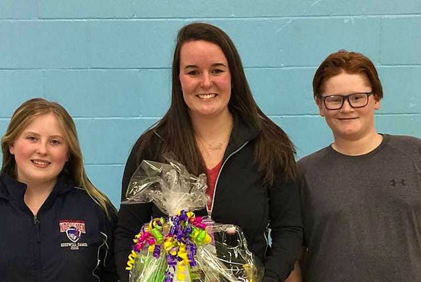 Ashley Praught receives a gift basket from the Georgetown Home and School Association at an awards ceremony at the school recently. Grade 8 students Mikaela Gallant, left, and Garrett O'Brien made the presentation.