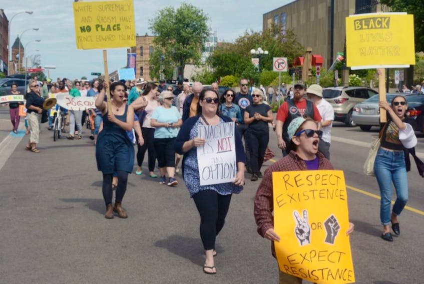 Participants march down Queen Street in the anti-white supremacy rally held in Charlottetown on Saturday.