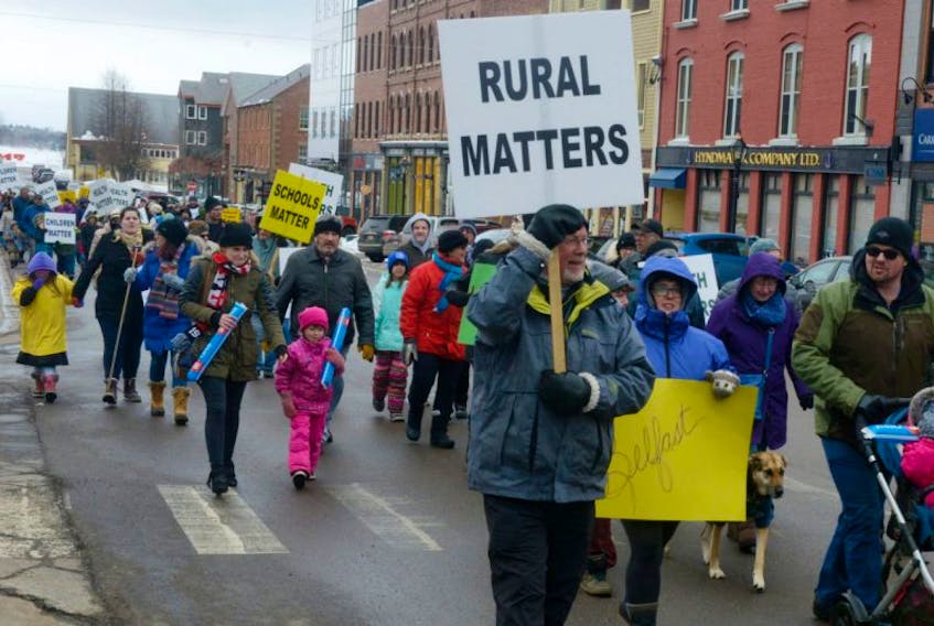Islanders march up Queen Street during a rally to highlight rural struggles that was held in Charlottetown on Monday.