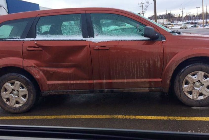 This photo shows the damage done to a Dodge Journey in a hit-and-run collision in the Maypoint Road roundabout in Charlottetown on Sunday. Police are looking for the driver of a grey half-tonne truck.  