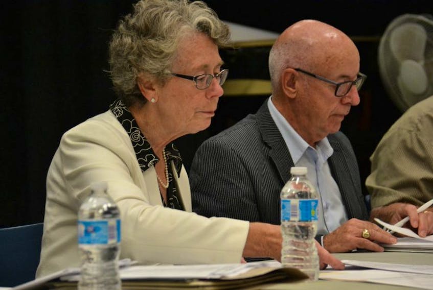 Public Schools Branch board of directors chair Susan Willis, left, and board member Harvey MacEwen prepare for a meeting held Tuesday at Stratford Elementary School.