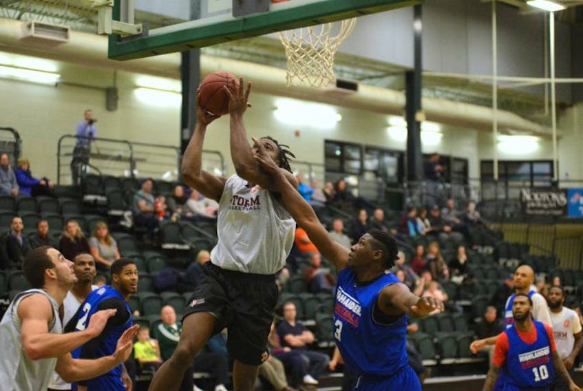 Island Storm forward A.J. Stewart, left, is fouled by Cape Breton Highlanders forward Shaquille Keith Tuesday during National Basketball League of Canada pre-season play at UPEI. Stewart started for the Storm and had 11 points, six rebounds, four blocks and two assists in 18 minutes.