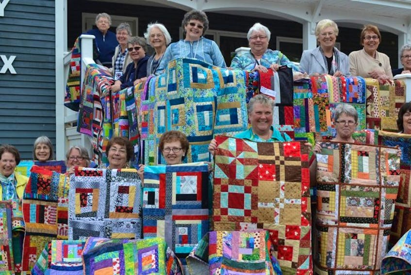 Members of the Northern Lights Quilt Guild display the three dozen quilts they made and donated for Canada’s Big Quilt Bee. The Quilt Canada project, in celebration of Canada’s 150th anniversary, seeks to supply Ronald McDonald houses across the country with 1,000 new quilts.