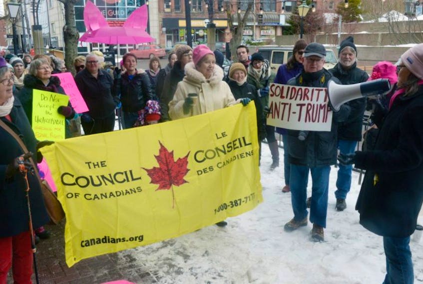 Organizer Susan Hartley speaks to the crowd during a march aimed at voicing opposition to U.S. president Donald Trump while also advocating for women’s rights in Charlottetown Saturday.