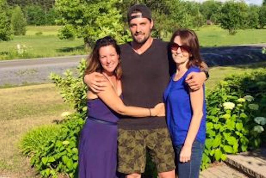 ['Francis Menard is pictured earlier this year with his birth mother, Melanie Cantwell, left, and his adoptive mother, Martine Chartrand, at his adoptive parentsâ\x80\x99 home in Embrun, Ont. Francis, 24, was reunited with Cantwell and his birth father, Alan MacQuarrie of Crapaud, after an article appeared in The Guardian in July. Menard approached the paper in a last-ditch effort to find his birth parents.']