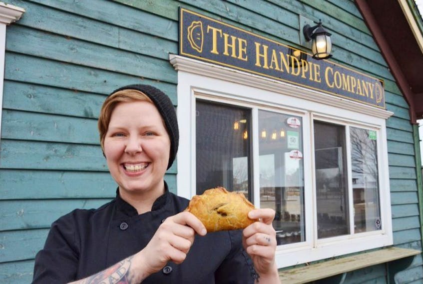 Sarah Bennetto O’Brien holds a hand pie outside of her shop, the Handpie Company in Gateway Village, Borden-Carleton. The shop used to be called Scapes, but has been rebranded to focus on hand pie production.