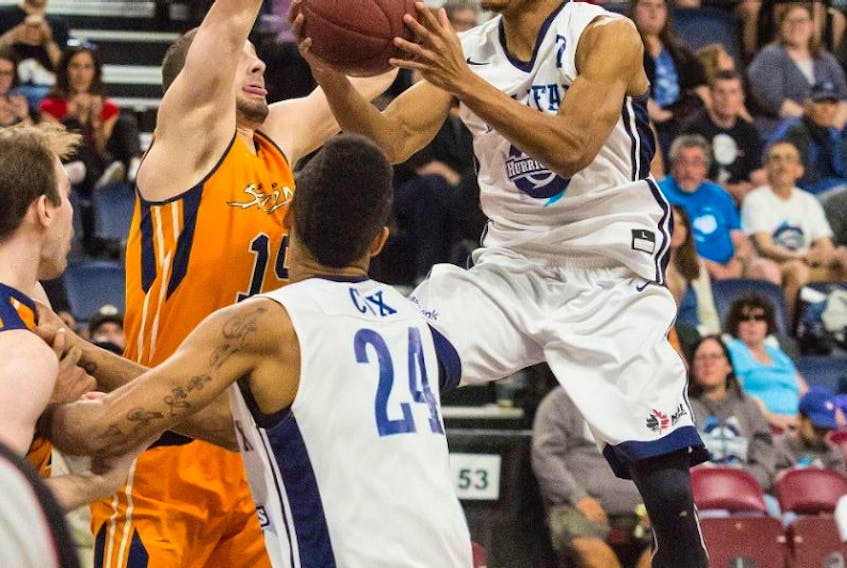 Halifax Hurricanes guard Joey Haywood gets a shot off as Island Storm forward Al Richter defends Monday in Halifax during Game 5 of the National Basketball League of Canada semifinal.