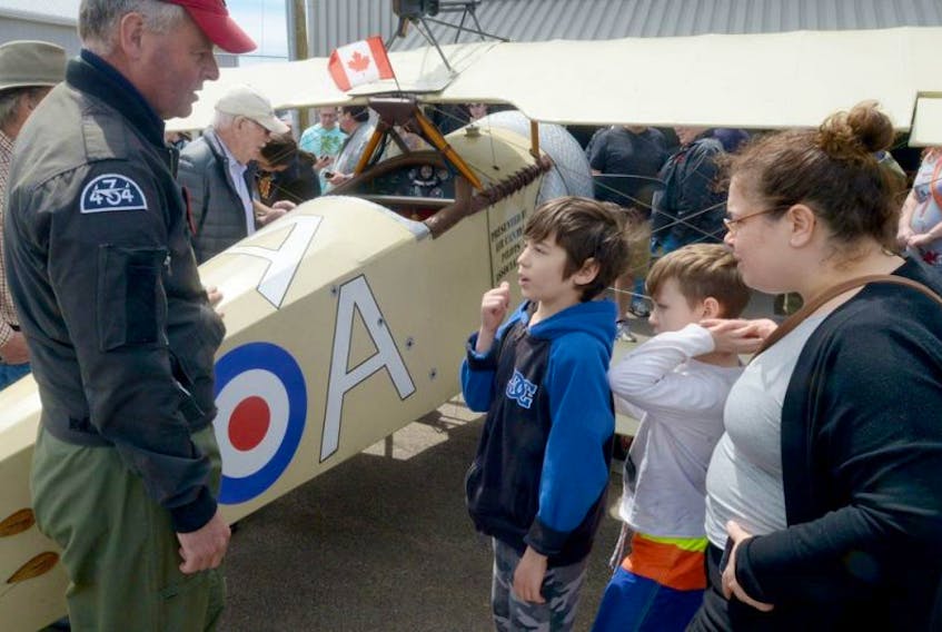Pilot Peter Thornton, from, chats with brothers George and Mikhail Lebedev and their mother Georgina Bassett next to a replica Sopwith Pup plane during the Charlottetown stop of the Birth Of A Nation tour being held by the “Vimy Flight” pilots. The pilots previously participated last month’s 100th anniversary commemoration of the Battle of Vimy Ridge in France.