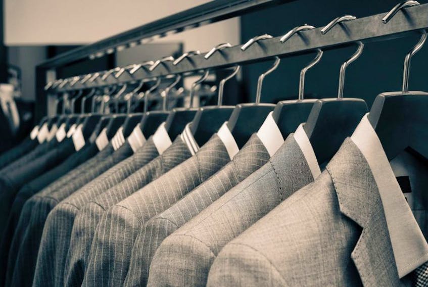 Suits hanging in a mens store.