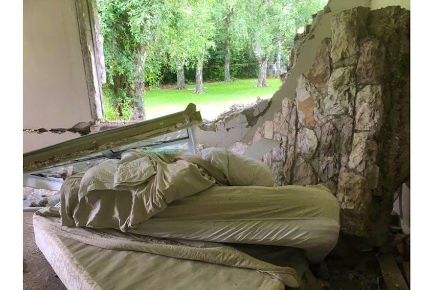A portion of wall collapsed on the coupleâs bed moments after they woke and got outside during an earthquake that hit New Zealand, where they were living at the time.