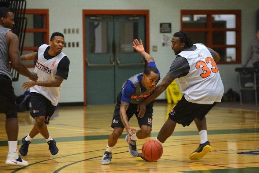 Island Storm point guard Al Stewart, left, drives into the paint on A.J. Stewart during practice Thursday at UPEI.