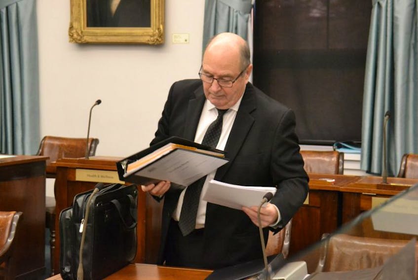 Finance Minister Al Roach prepares for the legislative assembly proceedings on Nov. 23, 2016.