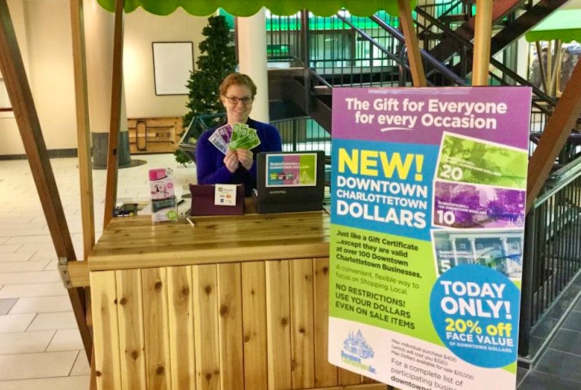Maria Maund shows off some Downtown Dollars as part of a new program designed to get people shopping at businesses in downtown Charlottetown.
