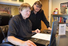 Lorraine MacDonald, left, receives help on the EPSI computer from the program’s executive director Gloria Schurman.