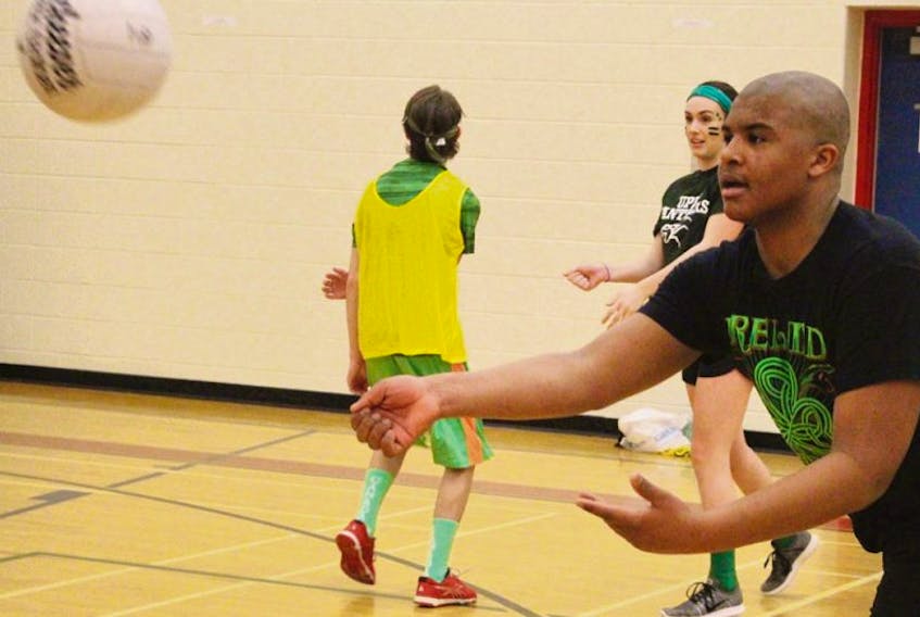 George Madumba practises passing during a Gaelic football drill at Athena Consolidated School in Summerside. Recently, Grade 9 students learned the rules and how to play the Irish sport.