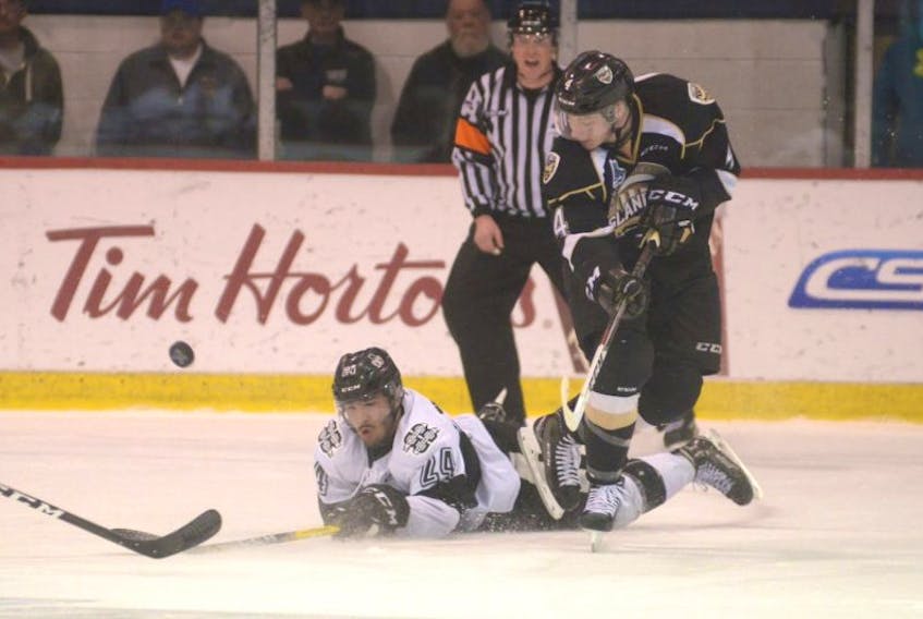 Charlottetown Islanders defenceman Nicolas Meloche clears the puck in front of Blainville-Boisbriand Armada forward Joel Teasdale during Friday's Game 1 at the Eastlink Centre.