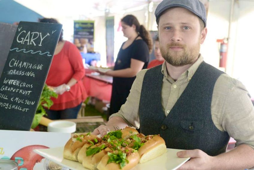 Chef Chris Campbell, of The Inn at St. Peters, shows his “Gary” lobster roll during the P.E.I. Lobster Festival at the Souris lighthouse. Campbell’s roll was a twist on the traditional take and featured a champagne vinaigrette and fried shallots.