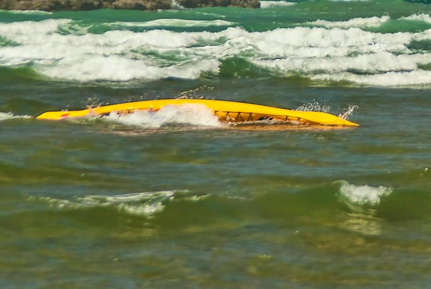 STOCK PHOTO: Overturned Kayak in ocean waves