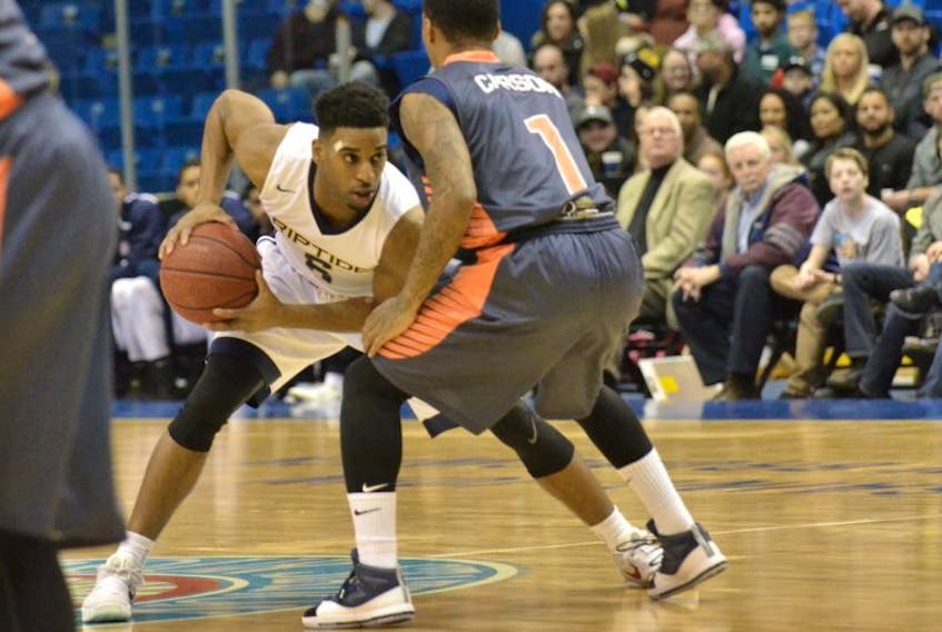 Saint John Riptide point guard Jabs Newby goes up against the Island Storm's Jahil Carson during Tuesday's NBL Canada action at Harbour Station.