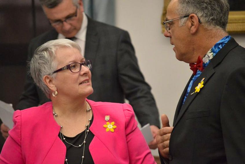 Paula Biggar, left, P.E.I.’s minister of transportation, infrastructure and energy, speaks with Souris-Elmira MLA Colin Lavie prior to question period in the P.E.I. legislature. 