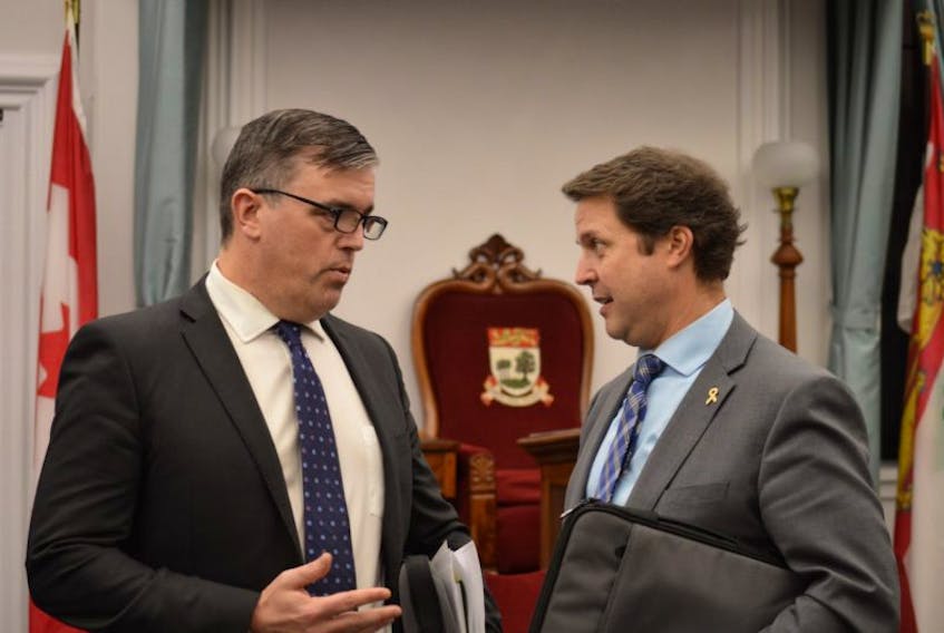 Opposition MLA Steven Myers seen here speaking with MLA Brad Trivers before legislature. On Tuesday, Myers accused the province of creating a "smokescreen" surrounding PISA results. 