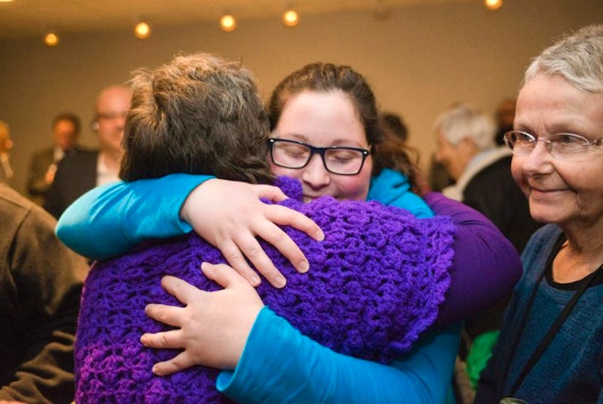 Colleen MacQuarrie, left, program director of the P.E.I. Status of Womens Council and Brittany Jakubiec, a UPEI student and pro-abortion advocate, hug after Premier Wade MacLauchlan announced earlier this year that the government will not oppose a constitutional challenge to provincial policies regarding access to in-province abortion services. The announcement was made during a news conferenc in Charlottetown with MacLauchlan, Robert Henderson, minister of health and wellness and Paula Biggar, minister responsible for the status of women.