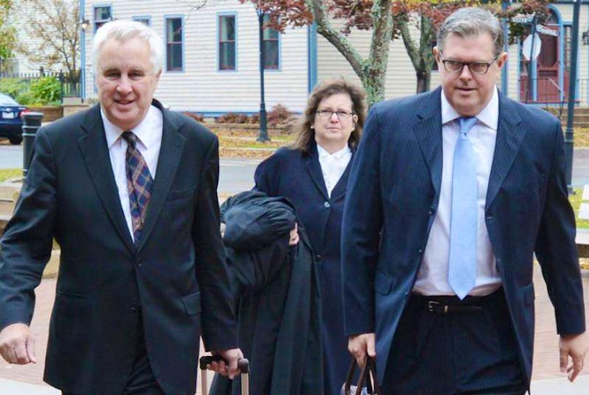 FILE PHOTO: Capital Markets Technologies lawyer John Findlay, left, enters the P.E.I. Supreme Court with CMT director Paul Maines.