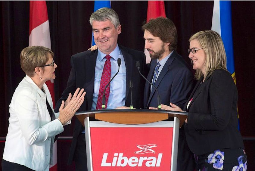 Nova Scotia Premier Stephen McNeil is embraced by his wife Andrea, daughter Colleen and son Jeffrey as he addresses the crowd at his election night celebration in Bridgetown, N.S. on Tuesday, May 30, 2017.