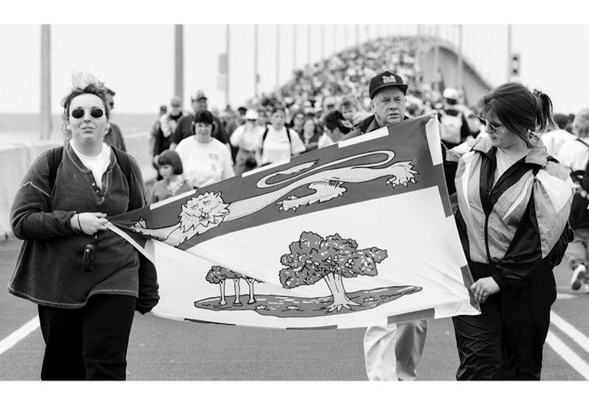 Kim Gallant, left, and Darla Gallant carried the P.E.I. flag across the Confederation Bridge in this photo published in The Guardian on May 31, 1997. Both women say it’s a day they will never forget.