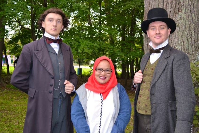 Newly sworn in Canadian citizen Dwitya Rulhadi poses with two of the Confederation Players in the roles of John A. Macdonald, left, and Edward Palmer during a citizenship ceremony in Charlottetown on Sept. 1.
