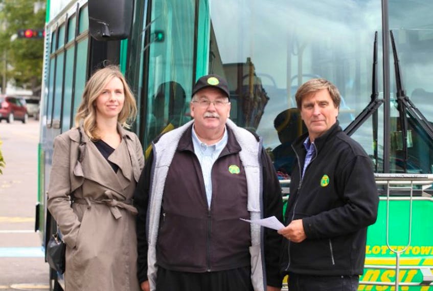 Ivan Proud, a driver who has been with T3 Transit since it began on Sept. 30, 2005, stands between T3 Transit Owner Mike Cassidy and the City of Charlottetowns Sustainability Officer Ramona Doyle. 
