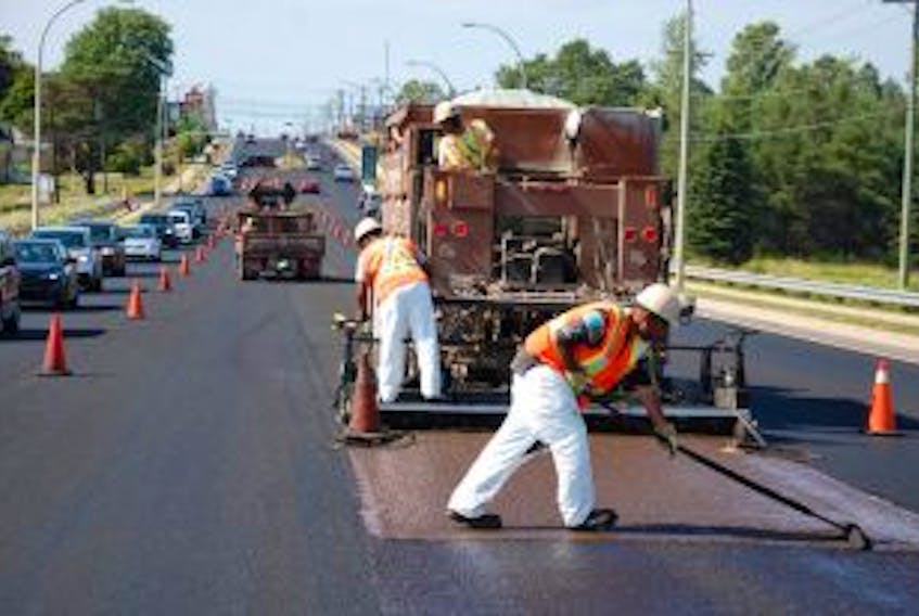 ['City of Charlottetown road crews work on resurfacing on University Avenue. The city has a resurfacing rating system to determine what level of repair work is needed for each city street each year.']
