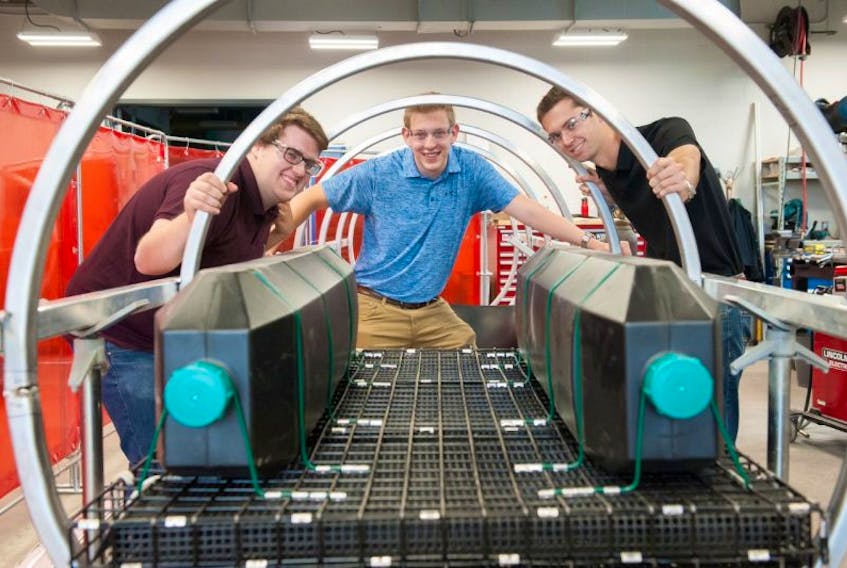 UPEI engineering students, from left, Brett McDermott, Dylan MacIsaac and Jordan Sampson, invented a machine that gently guides heavy oyster cages in a rollercoaster-like flip. The process keeps oysters healthier and more valuable. The students received a $25,000 Ignition Fund grant from the provincial government for their invention.