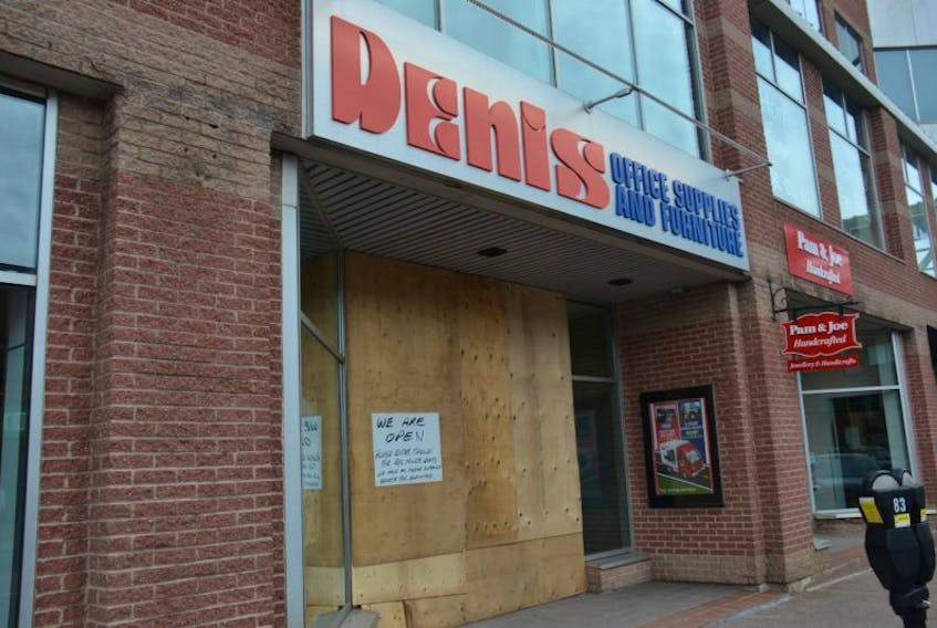 The storefront of Denis Office Supplies and Furniture on Kent Street may be boarded up, but the business is open after an SUV crashed into it Monday afternoon. 