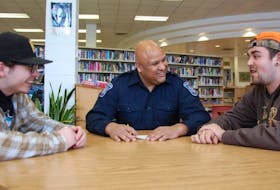 Const. Tim Keizer chats with Colonel Gray high school students Elijah Hood, left, and Jamie Crockett-Coffin. Keizer, who works as a school resource officer, is the 2017 recipient of the Rotary Club of Hillsborough's Vocational Service Award.