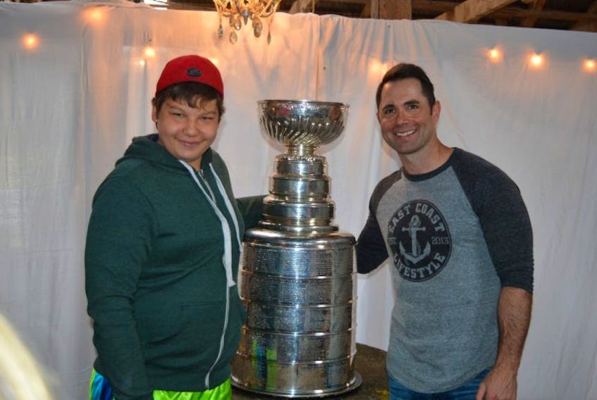 P.E.I. Special Olympics athlete Morgan Lubliek,left, of Tarantum poses with the Stanley Cup on Tuesday at Island Hill Farm in Warren Grove. Andy O’Brien, director of sports science and performance with the Pittsburgh Penguins, said his goal was to share his day with the Cup with at least one charity.