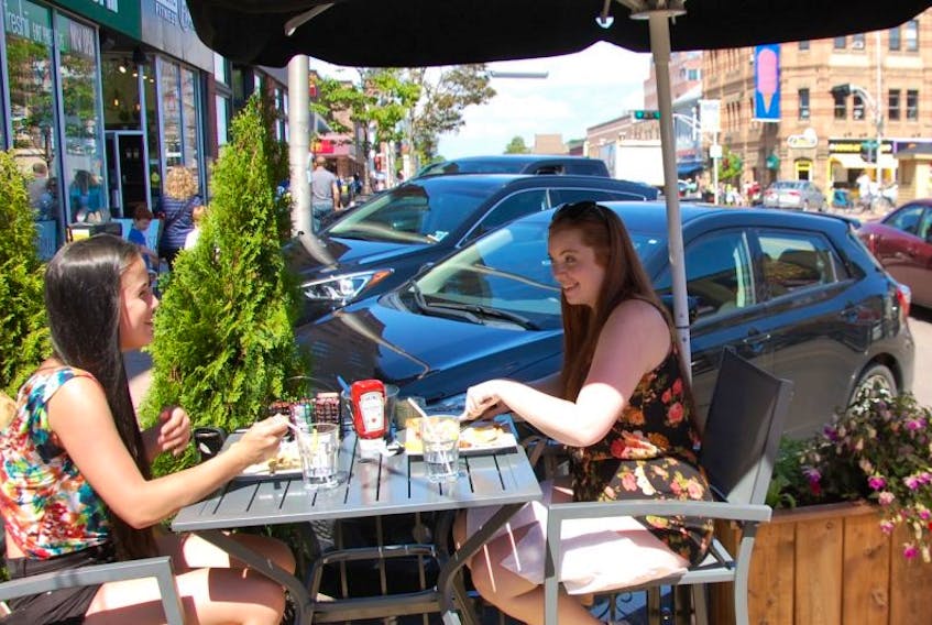 JIM DAY/THE GUARDIAN Martha Day, left, 18, of Charlottetown and Hannah Morgan, 20, of Truro, N.S. both chose to have a breakfast meal for lunch on the deck at Casa Mia Café on Queen Street.