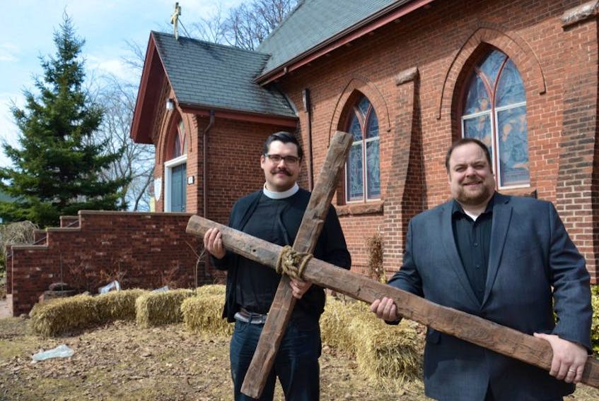 Rev. Colin Nicolle and Rev. Eddie Rossiter hold the cross that will be carried to six different churches in Summerside on Good Friday. 