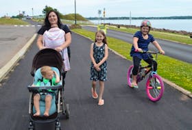 Kayla Hainer, pushing the stroller, found out the hard way that she’s allowed to push her child in a stroller on the cycling lane at Charlottetown’s Victoria Park as long as her other daughter is on her bicycle beside her. Hainer said she was verbally accosted by a cyclist on Tuesday night for being on the cycling lane with a stroller. Also pictured are her son, Brayden Thompson (in the stroller), her daughter, Blake Thompson (in the baby holder), her daughter, Trinity Hainer (on the bicycle); and Chloe Coggar (walking), a child Hainer babysits.