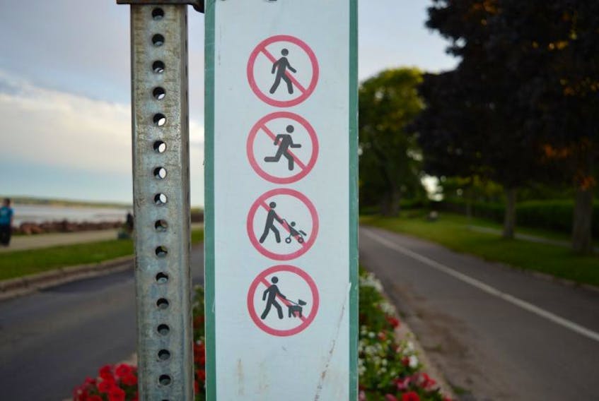 The City of Charlottetown has these signs posted at either end of the cycling lane at Victoria Park. It states that walking, running, pushing strollers and walking dogs are prohibited.
