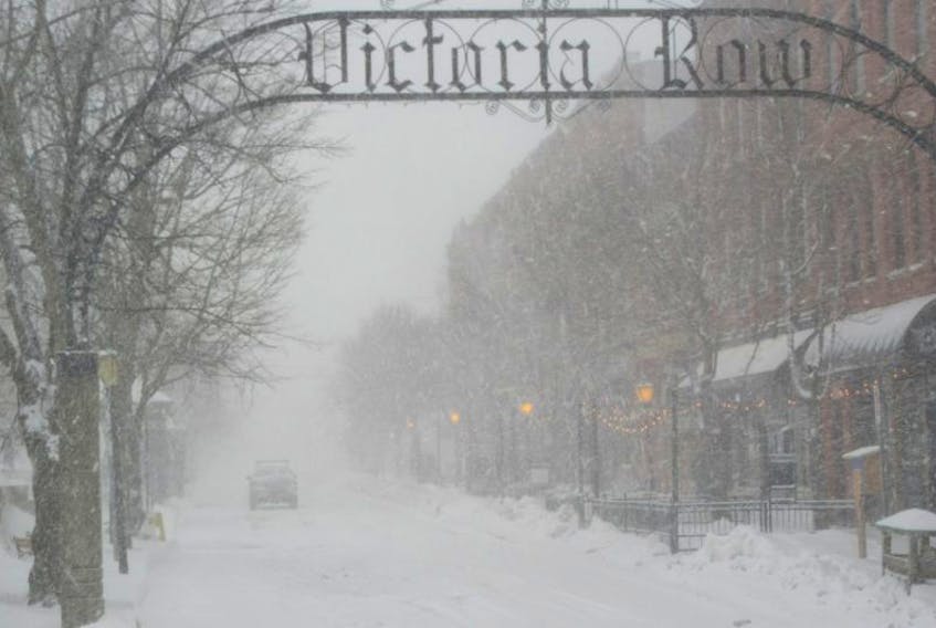 A few lights added a bit of warmth to the winter scene on Victoria Row as the snowstorm ramped up Monday afternoon