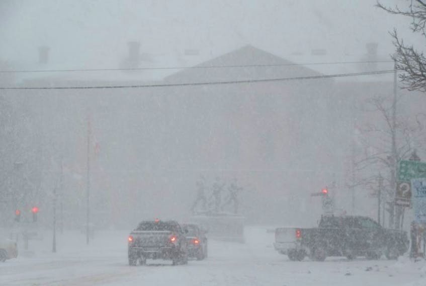 The shadow of Province House is just visible in the blowing snow early Monday afternoon in Charlottetown. There were still some cars out on the streets, although police and RCMP have issued advisories not to drive.