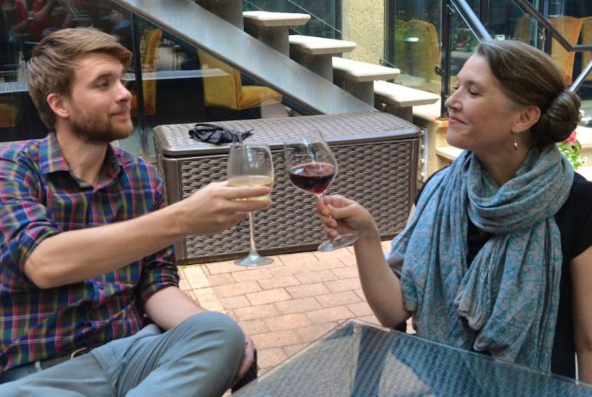 Confederation Centre of the Arts employees Fraser McCallum and Cecily Lalonde take a break at Mavors to enjoy a glass of wine after work this week.
