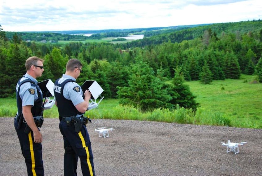 Cpl. Al Vincent, left, Prince District RCMP, and Const. Conor Hickey, Kings District RCMP, conduct a demonstration Wednesday at Strathgartney Provincial Park for the media on the new drones the police force has purchased. Officers from across P.E.I. are now trained in the use of the unmanned aerial vehicles (UAVs).