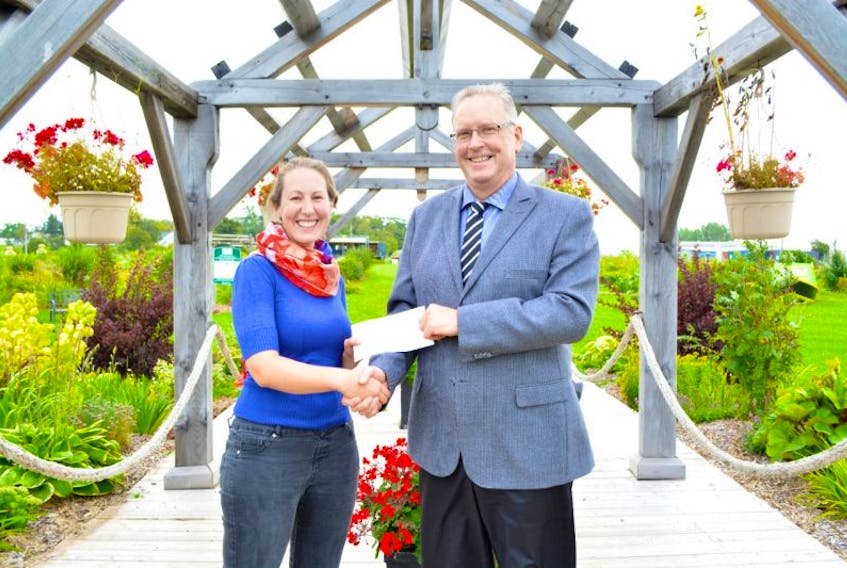 Doug Bridges, from Provincial Credit Union, presents a $1,000 cheque to Stephanie Palmer from The P.E.I. Certified Organic Producers Co-operative.