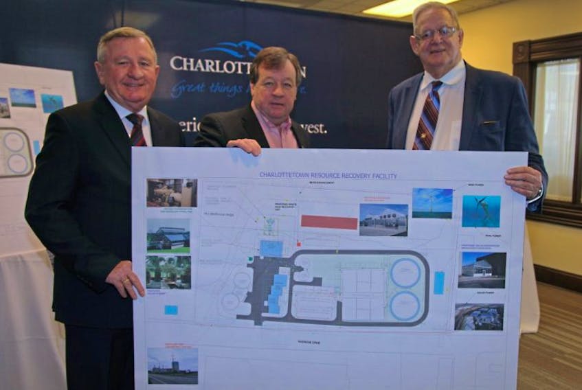 From left, Deputy Mayor Mike Duffy, chairman of the environment and sustainability committee, joins Charlottetown Mayor Clifford Lee and Coun. Eddie Rice, chairman of the water and sewer utility committee, to display a diagram of the proposed changes at the pollution control plant.