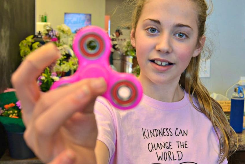 Fidget spinners are the latest kid craze. Jessica Robichaud, 12, who is from Summerside, displays her pink-coloured one. 