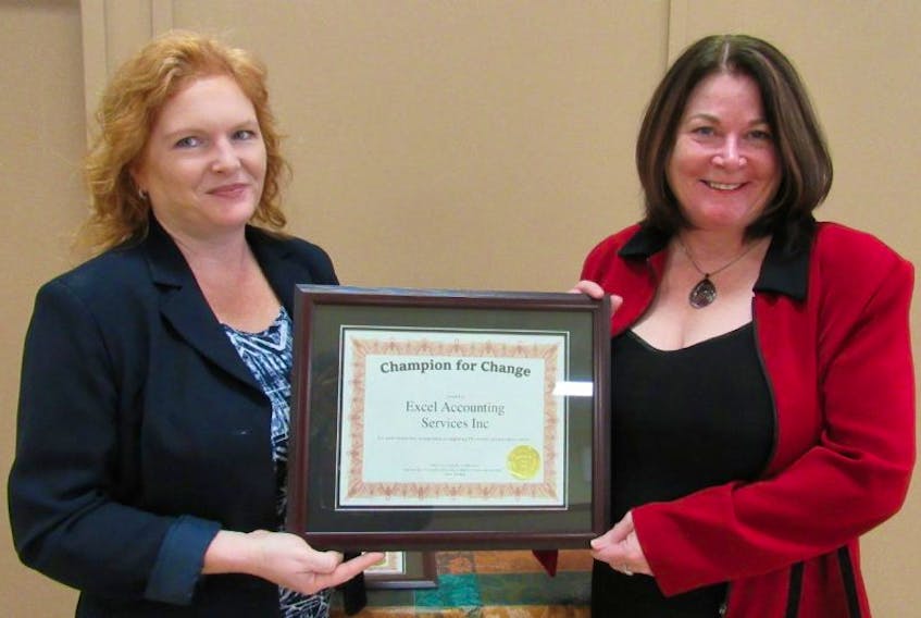 Adventure Group executive director Roxanne Carter-Thompson, left, presents Excel Accounting Services Inc. owner Sherry White with a “Champion for Change” award for diligence in supporting women to advance in the work place. 